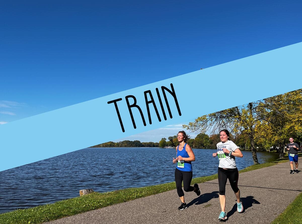 Two people running by the water